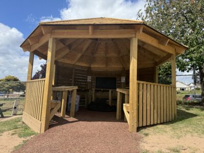 Outdoor Classroom with desks and a chalkboard